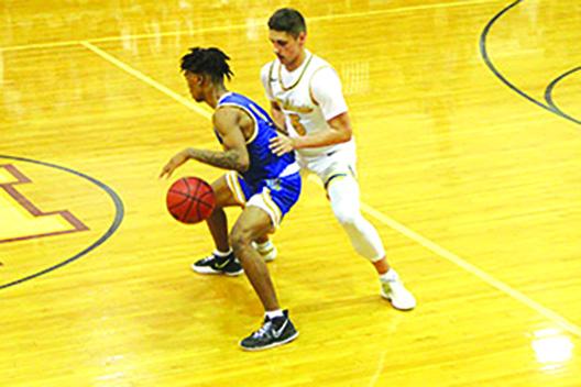 Palatka’s Chavaris Dumas is guarded tightly by Forest’s Mason Mascaro during Saturday’s game at North Marion High School. (COREY DAVIS / Palatka Daily News)