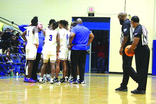 Palatka coach Bryan Walter (second, left) talks to his team during a first-half timeout in Tuesday night’s win against Williston. (MARK BLUMENTHAL / Palatka Daily News)