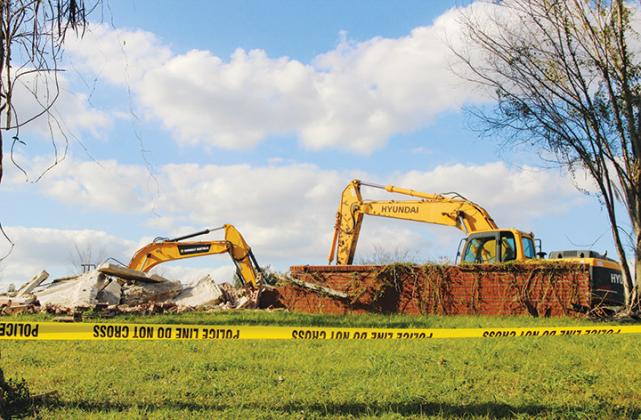 Two excavators sit unoccupied Wednesday on the Florida Furniture building property on River Street in Palatka.