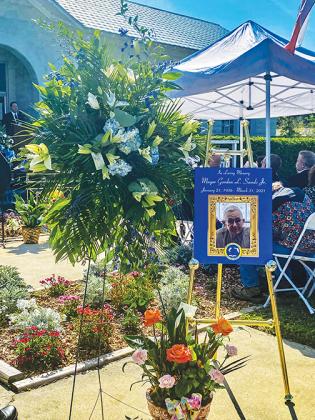 Flowers and a photo tribute to former Welaka Mayor Gordon Sands are posted outside Welaka Town Hall at his funeral in March. 