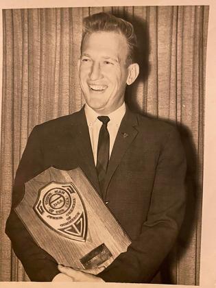 Floyd holds his Junior Chamber Young Man of the Year plaque in 1963.