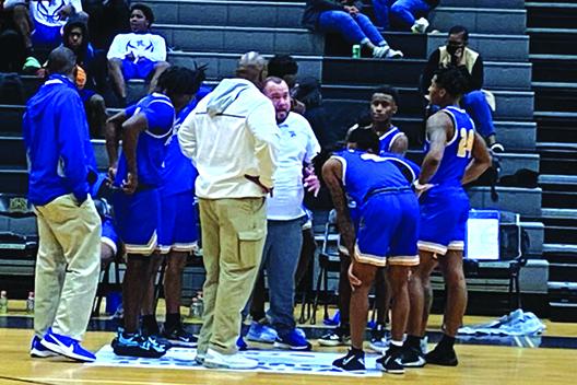 Palatka head coach Bryan Walter (center) talks to his players during a timeout in Friday night’s game with Orange Park Oakleaf. (COREY DAVIS / Palatka Daily News)