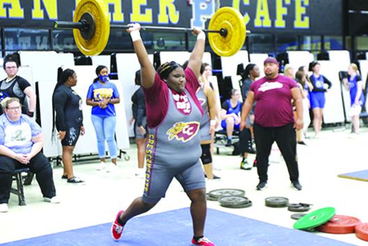 Unlimited division competitor Paris Clemons delivers a successful clean-and-jerk lift at the Putnam County Championship in December. (COREY DAVIS / Palatka Daily News)