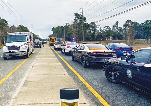 Putnam County Sheriff’s Office, Florida Highway Patrol and the county’s Emergency Services officials are seen at the crash site at Crill Avenue involving a car and a school bus early Tuesday morning.