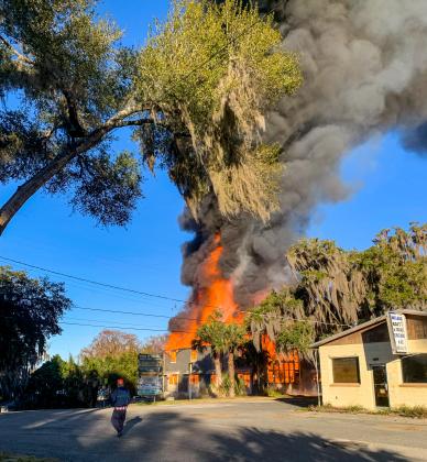 Photo courtesy of Welaka Mayor Jamie Watts. Flames rise from the former Welaka boat repair building at the corner of Front and Elm streets early Monday morning. 