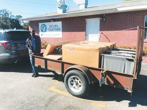 A Life Church Palatka volunteer helps bring in cot supplies this weekend for the church’s cold weather shelter