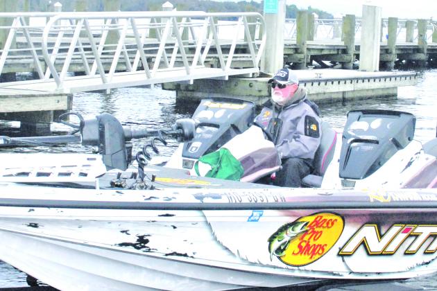 Rick Clunn, as recent a winner of the Bassmasters Elite at St. Johns River in 2019, sits in his boat along the Palatka dock Monday. (GREG WALKER / Daily News correspondent)