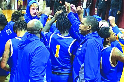 Palatka's boys basketball team huddles up before going on the court against North Marion Wednesday night. (COREY DAVIS / Palatka Daily News)