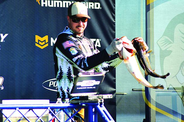 Second-place competitor Bob Downey shows of two of his catches Thursday during the opening day of the AFTCO Bassmaster Elite at St. Johns River. Downey weighed in 27 pounds, 4 ounces worth of catches. (CASMIRA HARRISON / Palatka Daily News)