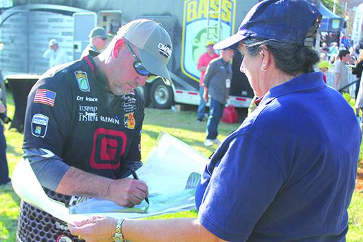 Palatka’s Cliff Prince signs an autograph after being eliminated for the weekend part of the tournament. (MARK BLUMENTHAL / Palatka Daily News)
