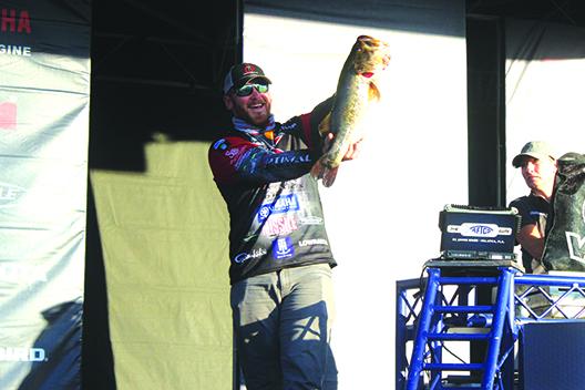Caleb Sumrall of New Iberia, Louisiana, who sits in 20th place going into today’s third round, shows off the biggest catch of the day Friday, a 9-pound, 7-ounce bass. (MARK BLUMENTHAL / Palatka Daily News)