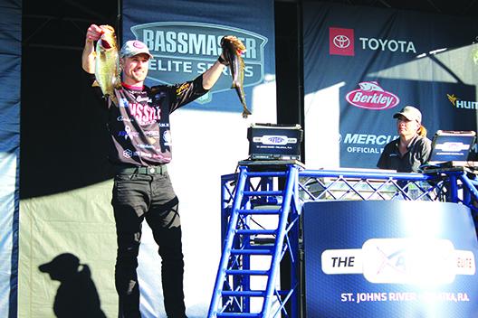 John Crews Jr. of Salem, Virginia shows off two of his catches as he continues to lead the tournament at the midway point. (MARK BLUMENTHAL / Palatka Daily News)