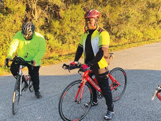 Rudy Gordon, right, prepares to embark on a bicycle ride along a trail in East Palatka. 