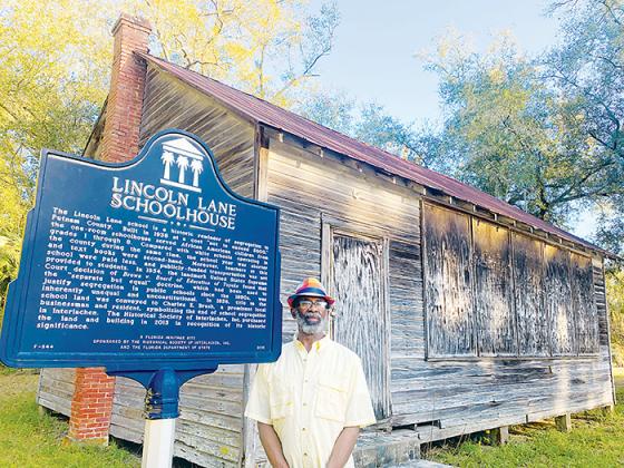 SARAH CAVACINI/Palatka Daily News Leo Granger, a member of the Interlachen Historical Society, stands in front of the Lincoln Lane Schoolhouse on Tuesday.