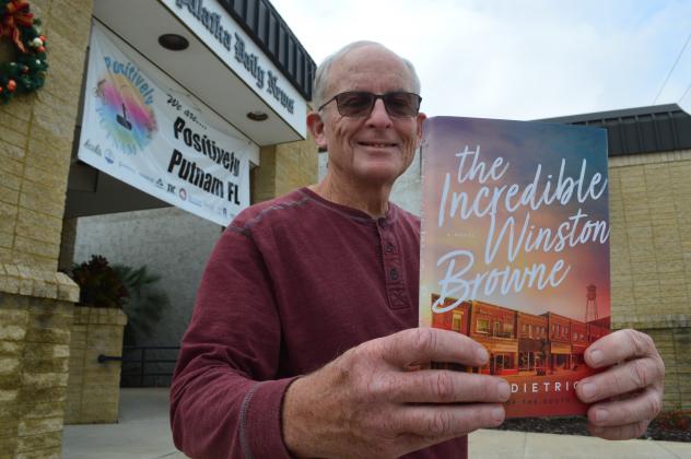 Bob Lee displays the One Book One Putnam pick for this season. Library discussions on the book are set to begin Wednesday. / Palatka Daily News file