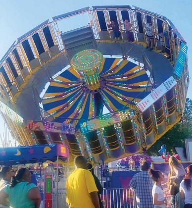 Some Putnam County Fair attendees spin on one of the rides while others wait in line on Sunday, the third day of the fair.