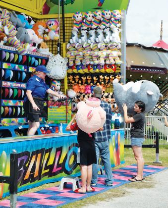 Attendees of the Putnam County Fair win big Saturday after bursting balloons with darts. 