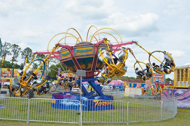 The Tornado whirls fair-goers through dizzying circles on Saturday, the second day of the fair. The Putnam County Fair will continue through the evening of March 26.