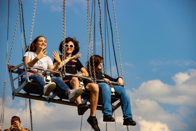 Palatka students Heaven Sapp, Reese Davis and Gabby Parnell wave from the flying swings at the Putnam County Fair on Friday evening. (Photos by Sarah Cavacini/Palatka Daily News)