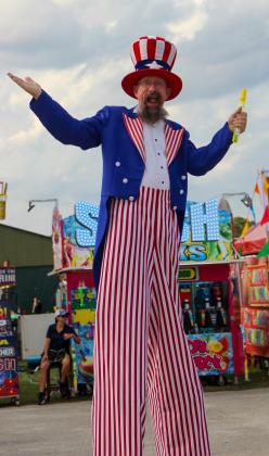 Stiltwalker Zak Asiago smiles Friday night during the opening evening of the Putnam County Fair. (Photos by Sarah Cavacini/Palatka Daily News)