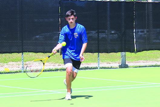 Palatka’s Aiden Carter returns a shot in a fifth singles first-round match on Tuesday. Carter would lose his opening match. (MARK BLUMENTHAL / Palatka Daily News)