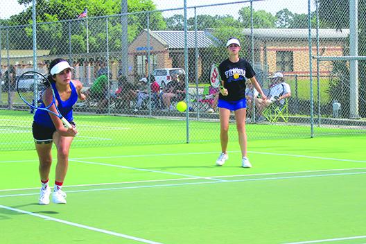 Palatka’s Paige Griner goes after a shot, while teammate Elle Herrington watches during Wednesday’s District 2-2A tournament second doubles semifinal against Gainesville Eastside. (MARK BLUMENTHAL / Palatka Daily News)