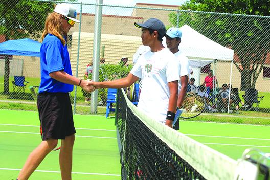 Palatka’s Wyatt Blevins shakes hands with Gainesville Eastside’s Bryson Ko, while Ko’s partner, Vedant Karalkar, waits to shake Blevins’ hand after the Eastside duo defeated Blevins and his brother, Mason, 6-0, 6-0, in District 2-2A second doubles semifinal on Wednesday. (MARK BLUMENTHAL / Palatka Daily News)