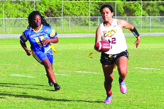Crescent City’s Kirabella Williams (12) looks to out-run Palatka’s Zari Clark during the first half. (RITA FULLERTON / Special to the Daily News)