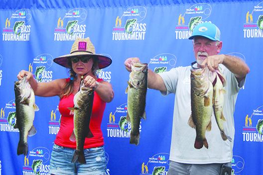 Phyllis Bollinger and Brett Bollinger show off some of their bass catch that saw the pair take fifth place with 18.08 pounds. (MARK BLUMENTHAL / Palatka Daily News)
