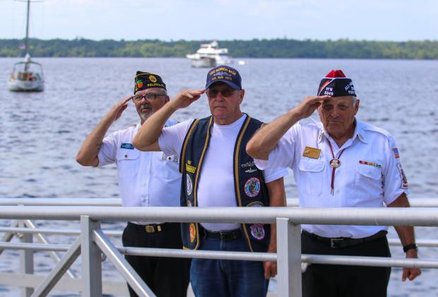(From left to right) American Legion Bert Hodge Post 45 Commander Ken Moore, U.S. Submarine Veterans Inc. Base Commander Ron Swiggert and Gerald Donnelly, commander of Veterans of Foreign Wars Post 3349 in Palatka salute fallen soldiers as taps play along the Palatka riverfront.  