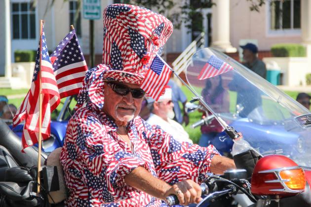 A man shows his Memorial Day spirit in a head-to-toe American flag ensemble as he rides in Palatka's Memorial Day parade on Monday 