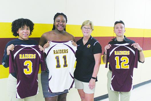 Former longtime Crescent City coach Holly Pickens (third from right) poses with All-County standouts (from left) Vicktoria Williams, Kayshia Brady and Alexis Sepulveda last September after their 2011 FHSAA 1A Final Four team was honored before a game. (MARK BLUMENTHAL / Palatka Daily News)