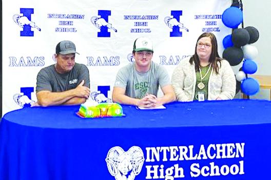 Interlachen’s Blake DeRossett, center, smiles after signing his letter of intent to play baseball at Enterprise State Community College last month. Enjoying the ceremonies are father Ron DeRossett and mother Melissa DeLoach. (COREY DAVIS / Palatka Daily News)
