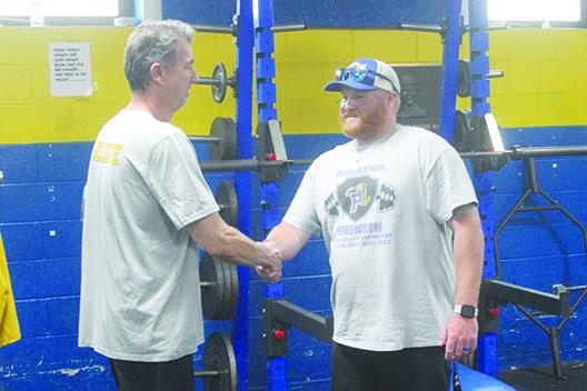 Palatka volleyball coach Robert Bush (left), the Daily News’ Coach of the Fall, shakes the hand of former boys weightlifting coach Dustin Whitlock, the Daily News’ Coach of the Spring honoree two weeks ago. (MARK BLUMENTHAL / Palatka Daily News)