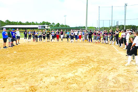 Players listen as several college coaches talk to the girls at the sixth annual North Florida Fastpitch College Prospect Combine Monday at Theobold Sports Complex. (COREY DAVIS / Palatka Daily News)