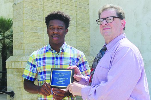 Recent Crescent City Junior-Senior High standout Naykeem Scott poses alongside sports editor Mark Blumenthal with the Daily News’ Senior Male Athlete of the Year honor. (SARAH CAVACINI / Palatka Daily News)