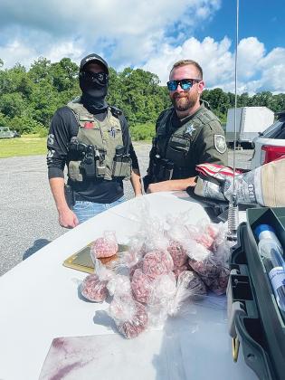 Deputies pose with roughly 10,000 doses of seized ecstasy pills Tuesday afternoon.