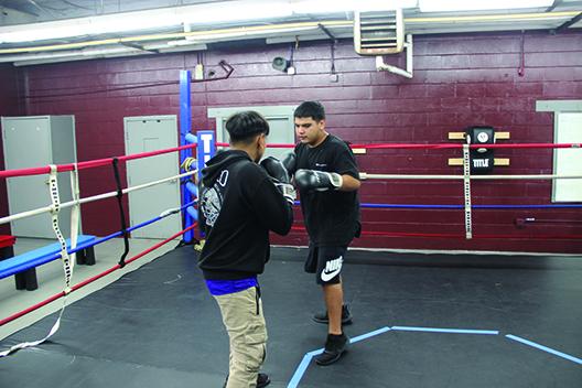 Fifteen-year old Ulises Acosta (left) spars with 17-year old Ryan Perez during the Police Athletic League Summer Camp Thursday at Crescent City Junior-Senior High School. (COREY DAVIS/ Palatka Daily News) 