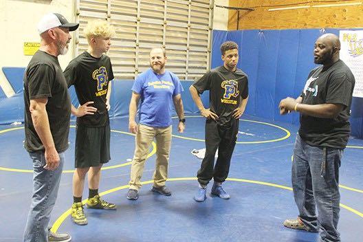 Palatka assistant wrestling coach Elysha Campbell (right) chats after a practice with (from left) assistant coach Richie Lewis, wrestler Brandon Lewis, head coach Josh White and wrestler Mikade Harvey. (MARK BLUMENTHAL/Palatka Daily News)