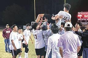 Crescent City teammates toss standout Jesus Cruz in the air after he scored all three goals in a 3-1 victory over host Pierson Taylor in the District 5-3A semifinals on Feb. 1. (MARK BLUMENTHAL/Palatka Daily News)
