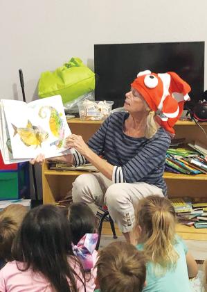 Susan Murphy, an Early Learning Coalition of North Florida volunteer and outreach assistant, reads “Mr. Seahorse” by Eric Carle to students at the Academy of Rising Stars in Palatka.