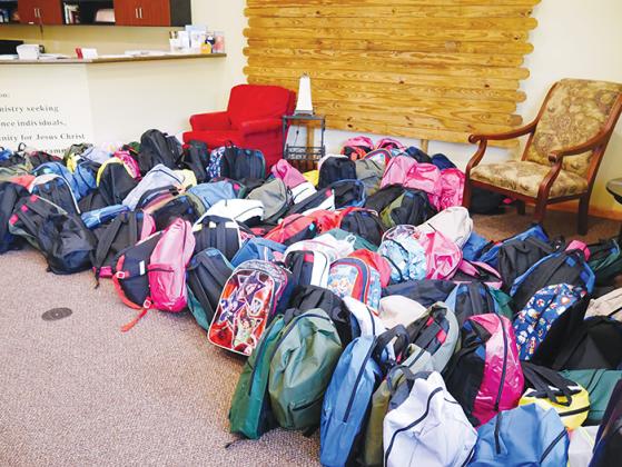 Backpacks that will be donated to Putnam County students rest on the floor at Hope FM in Palatka on Thursday.
