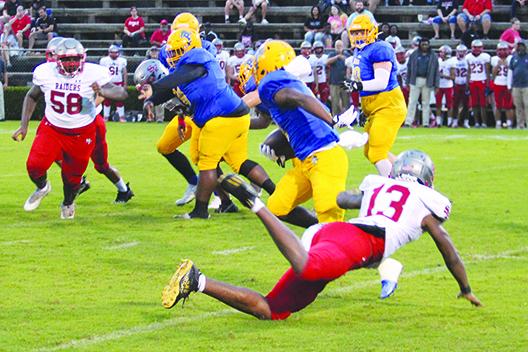 Palatka running back Saiquan Williams (center) makes Alachua Santa Fe defender Duke Lewis miss his tackle attempt during the Panthers’ 33-19 win on Sept. 9 at home. (MARK BLUMENTHAL/ Palatka Daily News)