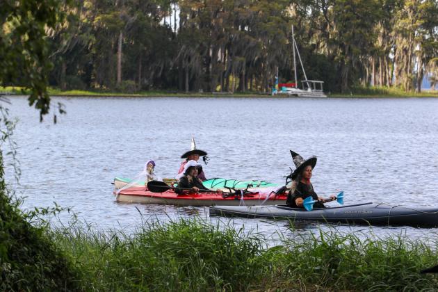 Three witches take their kayaks across Lake Santa Fe on Friday during this year's witches paddle in Melrose. 