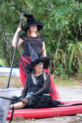 Keystone Heights woman Bonny Ivey (standing) and Hawthorne woman Leslie Skeans wait at the Melrose Boat Ramp Friday before heading onto Lake Santa Fe dressed as witches. 