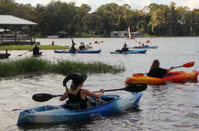 Witches and warlocks take over Lake Santa Fe in Melrose on Friday during the 2nd Annual Melrose Bay Witches Paddle, which raised money for the Melrose Center. 