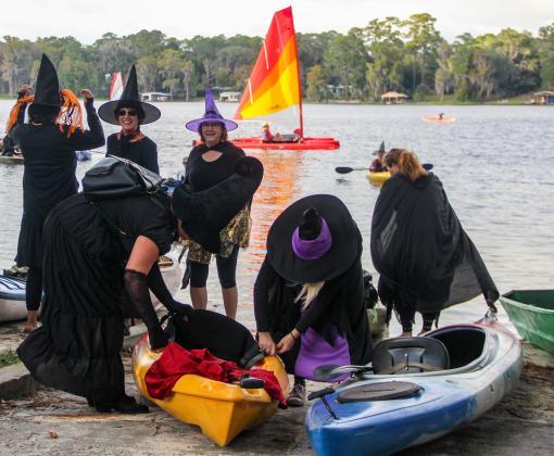 Women dressed as witches ready their kayaks at the Melrose Boat Ramp before participating Friday in the 2022 Melrose Bay Witches Paddle. 