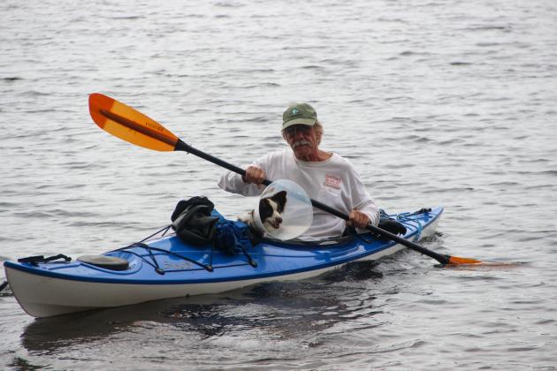 Mark Chiappini, who owns Melrose business Chiappinis, paddles with his canine companion Sky during Friday's paddle.
