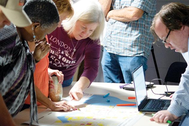 Robert Jordan, right, regional planner with Northeast Florida Regional Council, listens to Welaka residents weigh in on the potential borders of a future downtown area at a visioning session Tuesday.