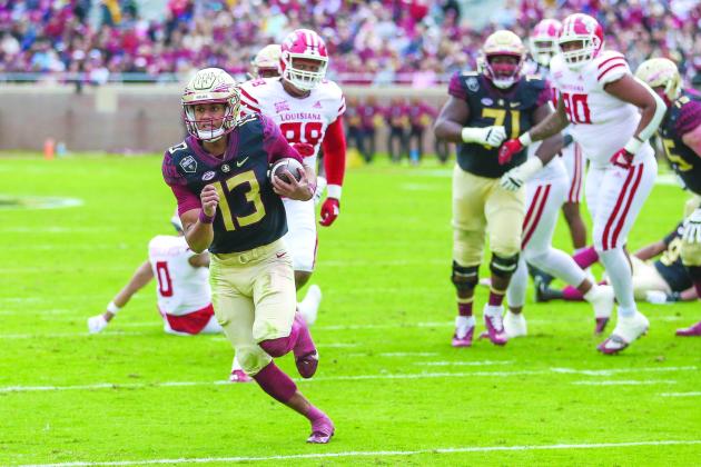 Florida State quarterback Jordan Travis scores on a 13-yard run during the first half against Louisiana last Saturday. (GREG OYSTER / Special to the Daily News)